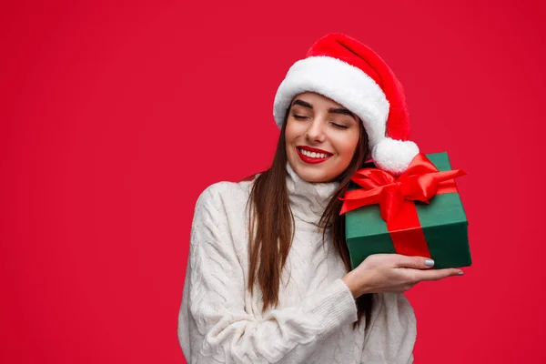 Happy woman guessing Christmas present in box — Stok fotoğraf