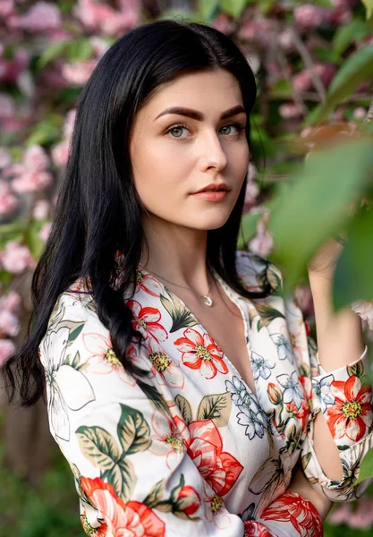 꽃이 피는 나무 근처에 완벽 한 피부를 가진우아 한 여인 — 스톡 사진