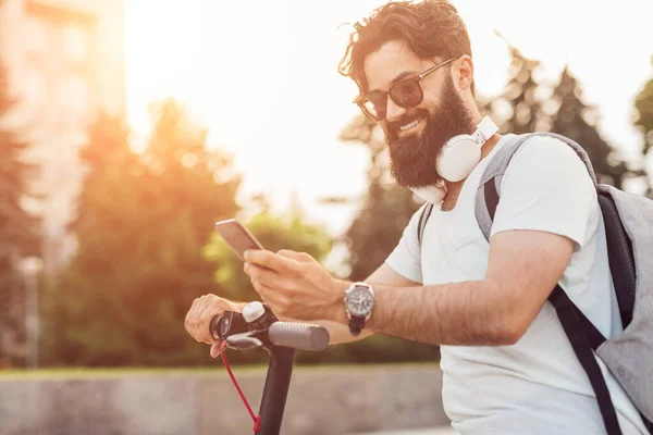 Wesoły hipster za pomocą smartfona podczas jazdy — Zdjęcie stockowe