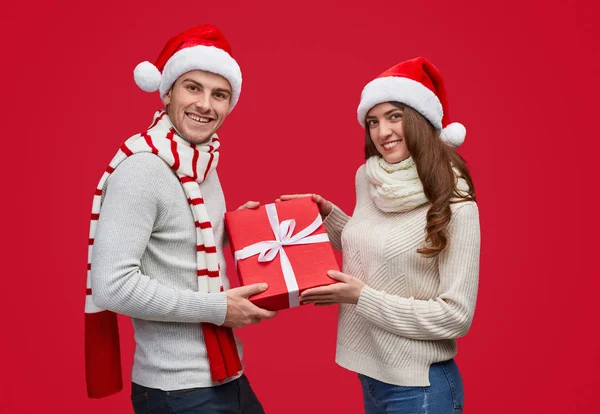 Noel hediyesi gösteren iyimser çift — Stok fotoğraf