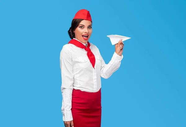 Amazed flight attendant near paper airplane — ストック写真