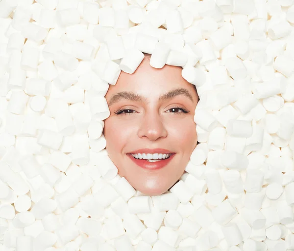 Delighted female in heap of marshmallows — Stock Photo, Image