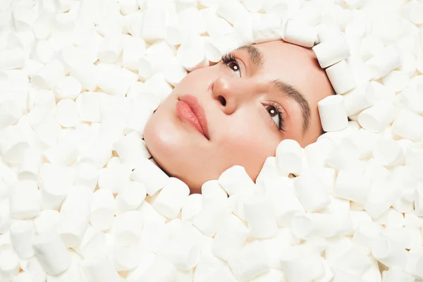 Young woman resting in marshmallows — Stock Photo, Image