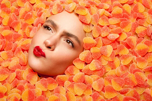 Woman trying fruit jelly candies — Stock Photo, Image
