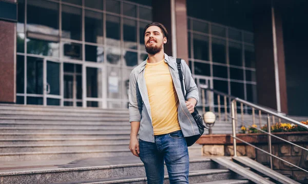 Estudiante alegre saliendo del edificio de la universidad —  Fotos de Stock