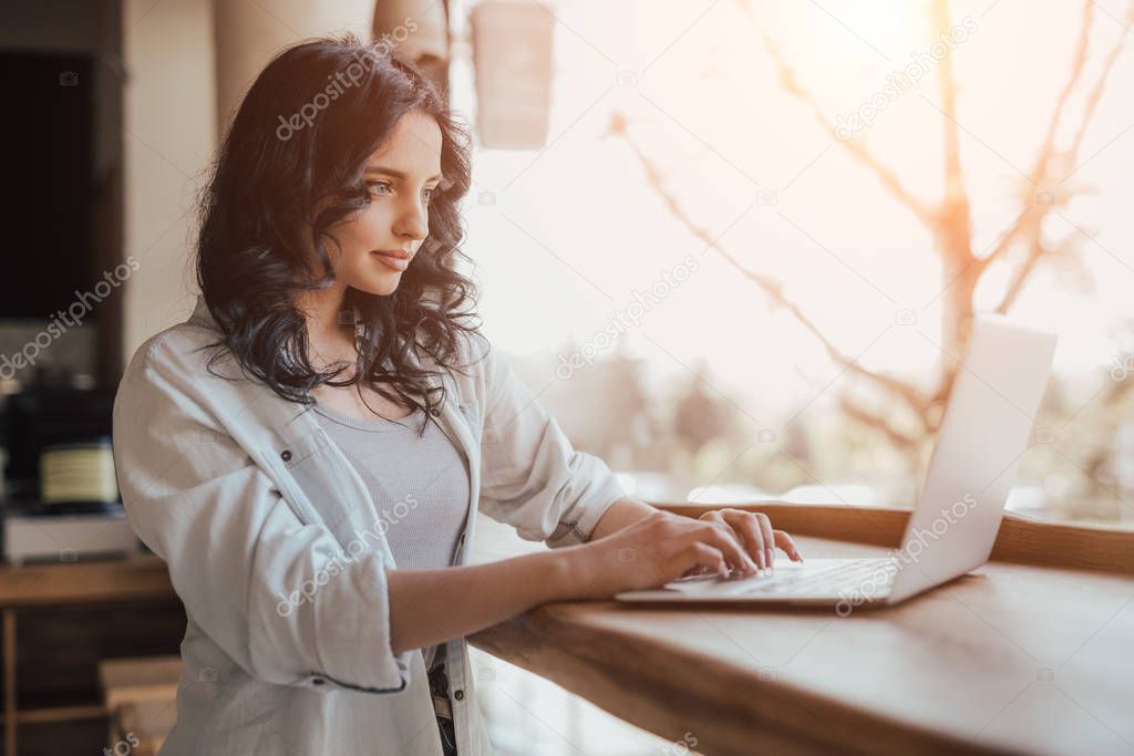 Female freelancer using laptop in cafe