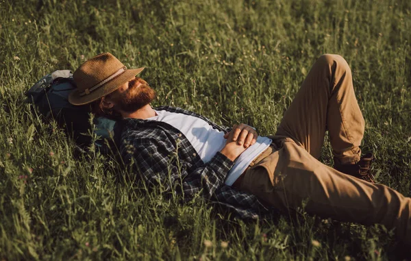 Bearded explorer sleeping on grass — Stock Photo, Image