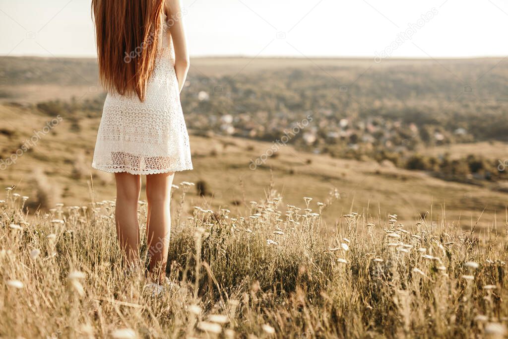 Lonely teen girl standing in field