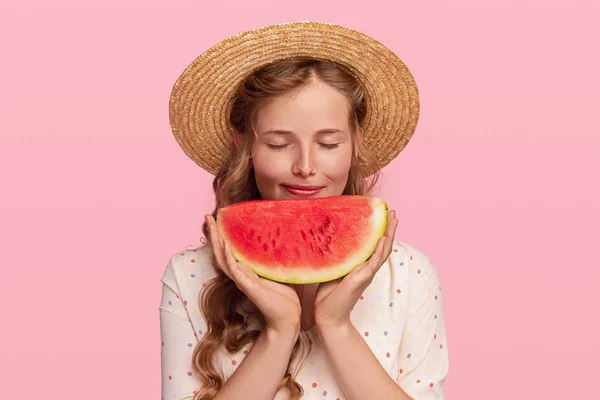 Pleased woman smelling fresh watermelon — Stock Photo, Image