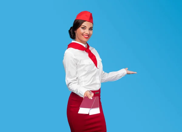 Friendly flight attendant inviting passengers on plane — 스톡 사진