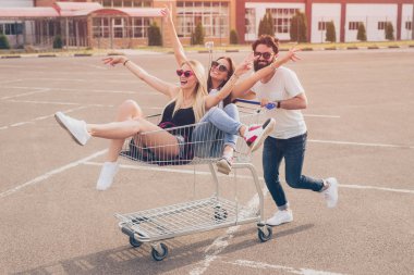 Carefree friends having fun on parking lot