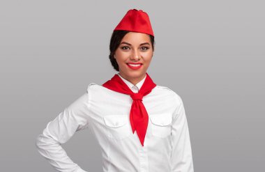 Friendly ethnic flight attendant smiling for camera