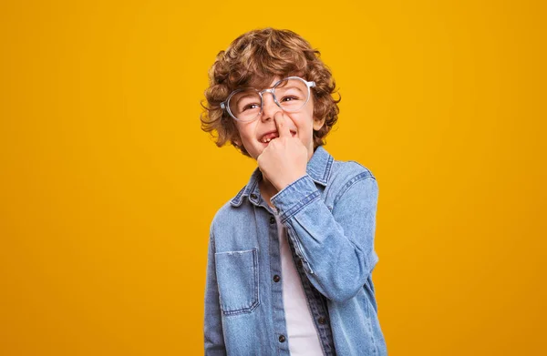 Silly boy smiling and picking nose — Stock Photo, Image