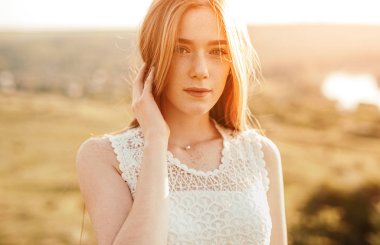 Calm ginger female with nature background