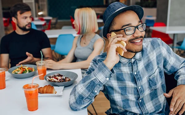 Cheerful modern man having phone conversation in cafe — Stock Photo, Image