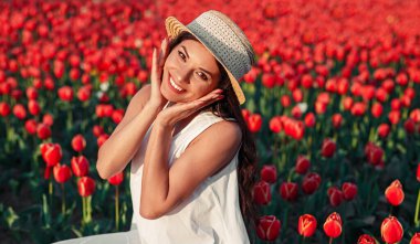 Cheerful woman smiling in tulip field