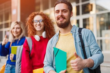 Cheerful students approving university studies