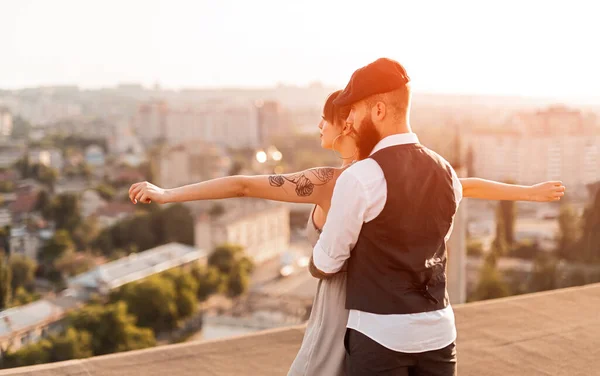 Romantic young couple looking at city from rooftop — ストック写真