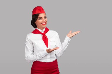 Hispanic stewardess demonstrating empty space