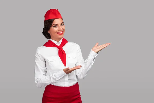 Hispanic stewardess demonstrating empty space — Stockfoto