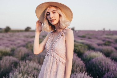 Stylish lady resting in blooming field