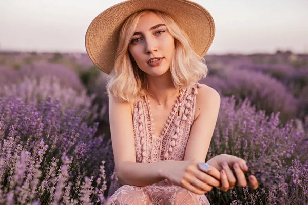 Magnificent young alluring woman with violet wildflowers in field — Φωτογραφία Αρχείου