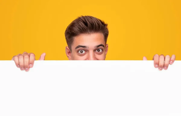 Young guy showing blank billboard — Stock Photo, Image