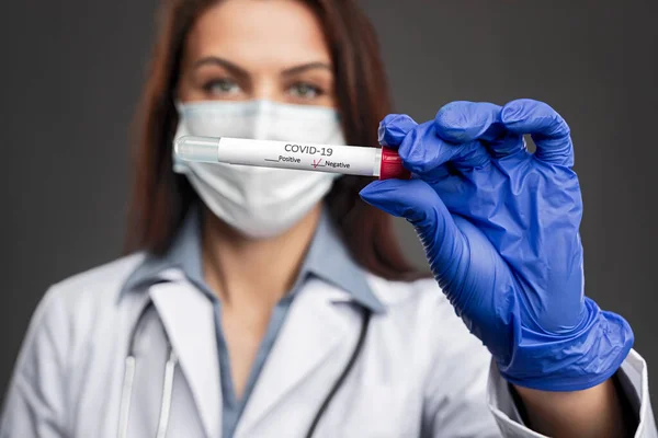 Doctor showing tube with negative coronavirus test — Stock Photo, Image