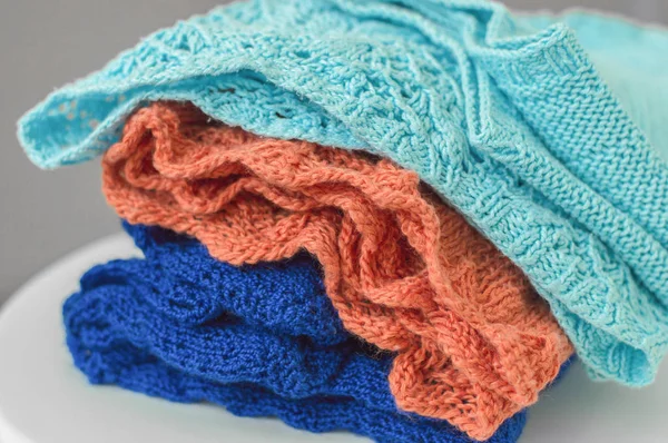 Örme kumaş yığını. Açık mavi, turuncu ve koyu mavi renk Triko