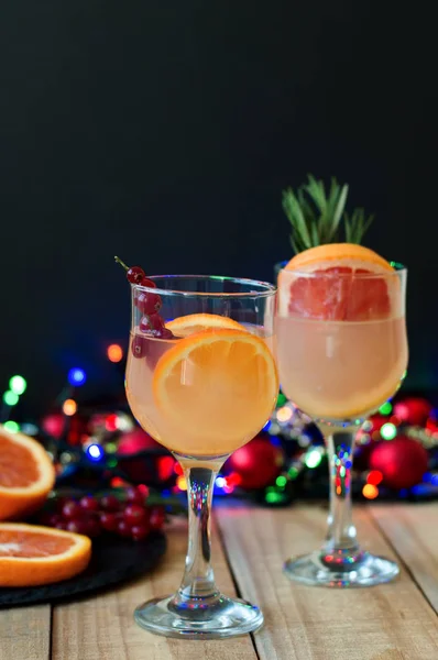 Lemonade with orange, grapefruit, red currant in wine glasses served with frut slices and christmas decoration. Celebration concept — Stock Photo, Image