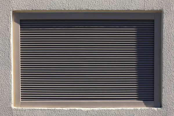Metal blinds in the plastered wall