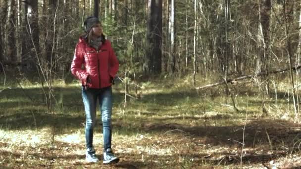 Девушка ходит по осеннему лесу — стоковое видео