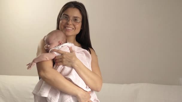 Young Mother Cradles Her Child Window Smiles — Stock Video