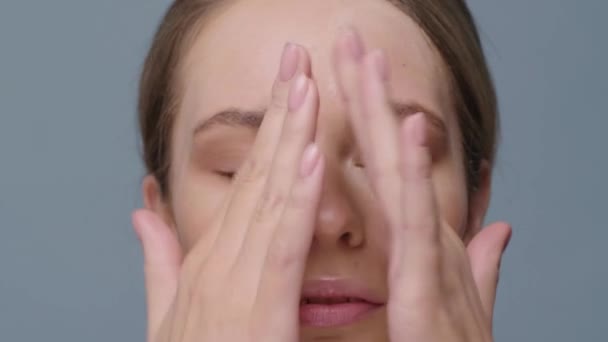 Girl Looks Camera Rubs Cream Her Face Close — Stock Video