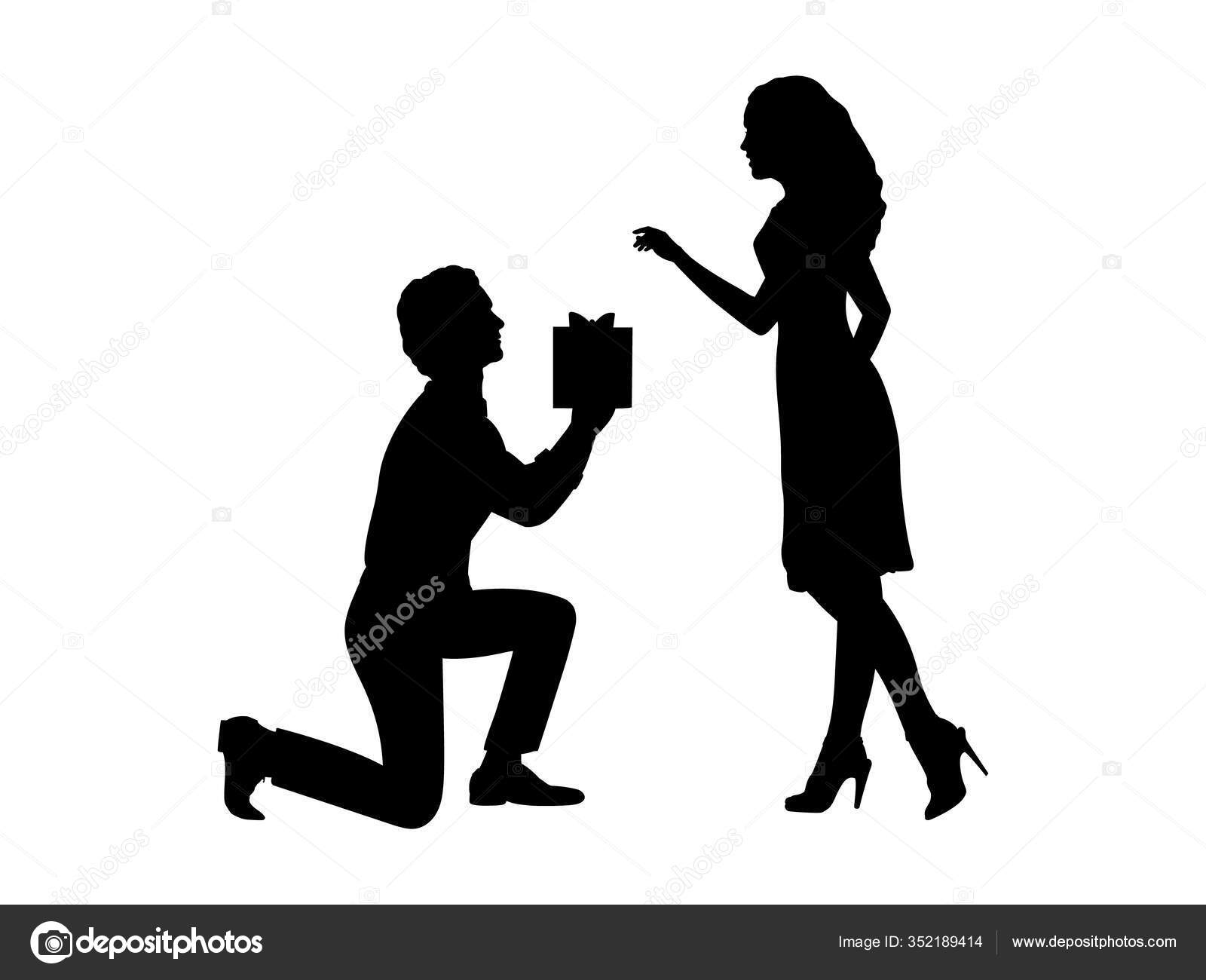 Silhouette de l homme debout sur son genou donne un cadeau Silhouette de l homme debout sur son genou donne un cadeau