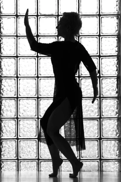 Woman`s silhouette with window