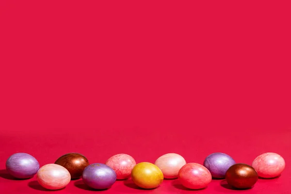 Easter painted eggs isolated on red paper background