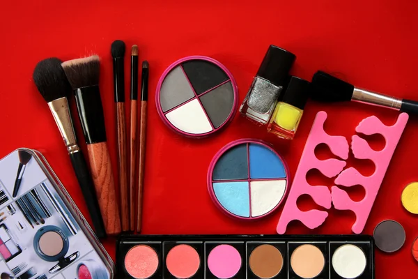 Makeup collection.Eye shadow,  brushes isolated on red background Stock Image