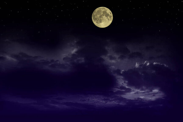 Beautiful magic blue night sky with clouds and fullmoon stars.