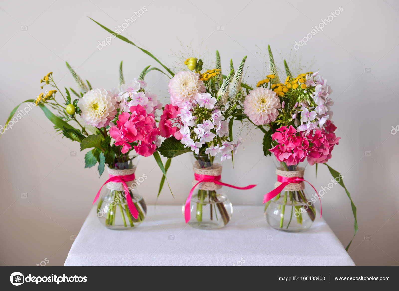 Small vases of flowers Three vases with flowers with small bouquets
