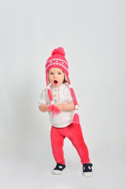 Bir kap ve kazak, küçük kız. Gri bir arka plan üzerinde izole.