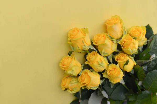 Ein Strauß gelber Rosen mit Blättern auf einem isolierten Hintergrund. Flache Lage, Draufsicht. Eckkomposition. Postkarte Geburtstag Blumenschmuck Stockfoto