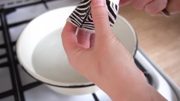 Homemade chicken eggs decor for the holiday of Easter in a bowl of boiled water sticker made of plastic animal zebra print — Stock Video