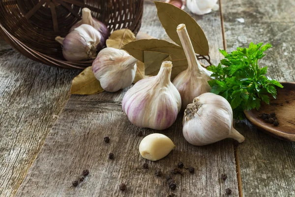 Garlic with spices on an old wooden background