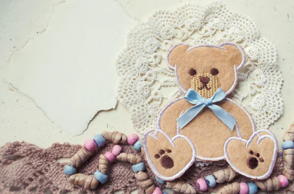 Decorative photo collage in vintage style with teddy bear and textile elements. — Stock Photo, Image