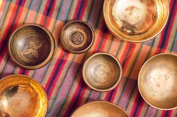 Tibetan singing bowls. View from above. Asian music instruments for relaxation and meditation. Accessories for sound massage. Close up of alms bowls, meditation bowls.