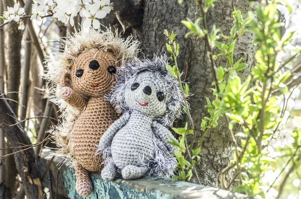 Crochet toy hedgehog on natural background. Cute handmade souvenir.