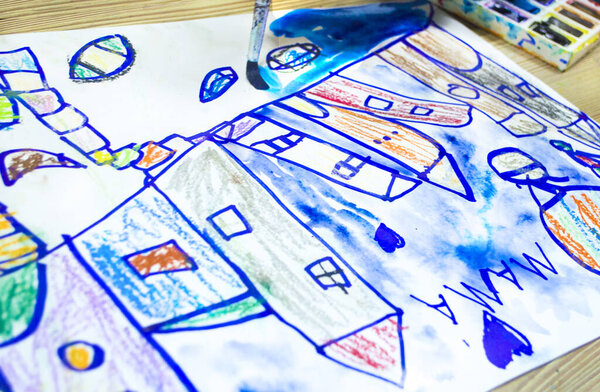 Children's drawing fairy-tale city houses for mom. Mom's day concept photo.