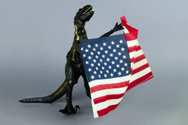 Big Black Plastic Toy Dinosaur Holding Usa Flag Gray Background — Stock Photo, Image