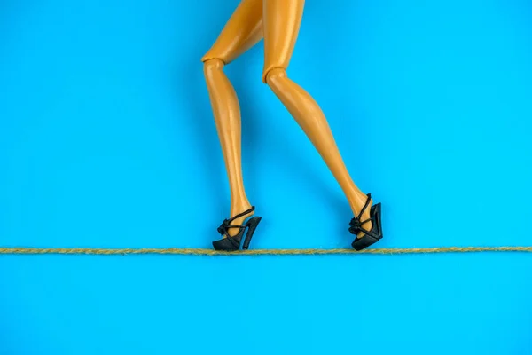 Legs Plastic Doll Black Shoes Walking Tightrope Blue Background Strategy — Stock Photo, Image